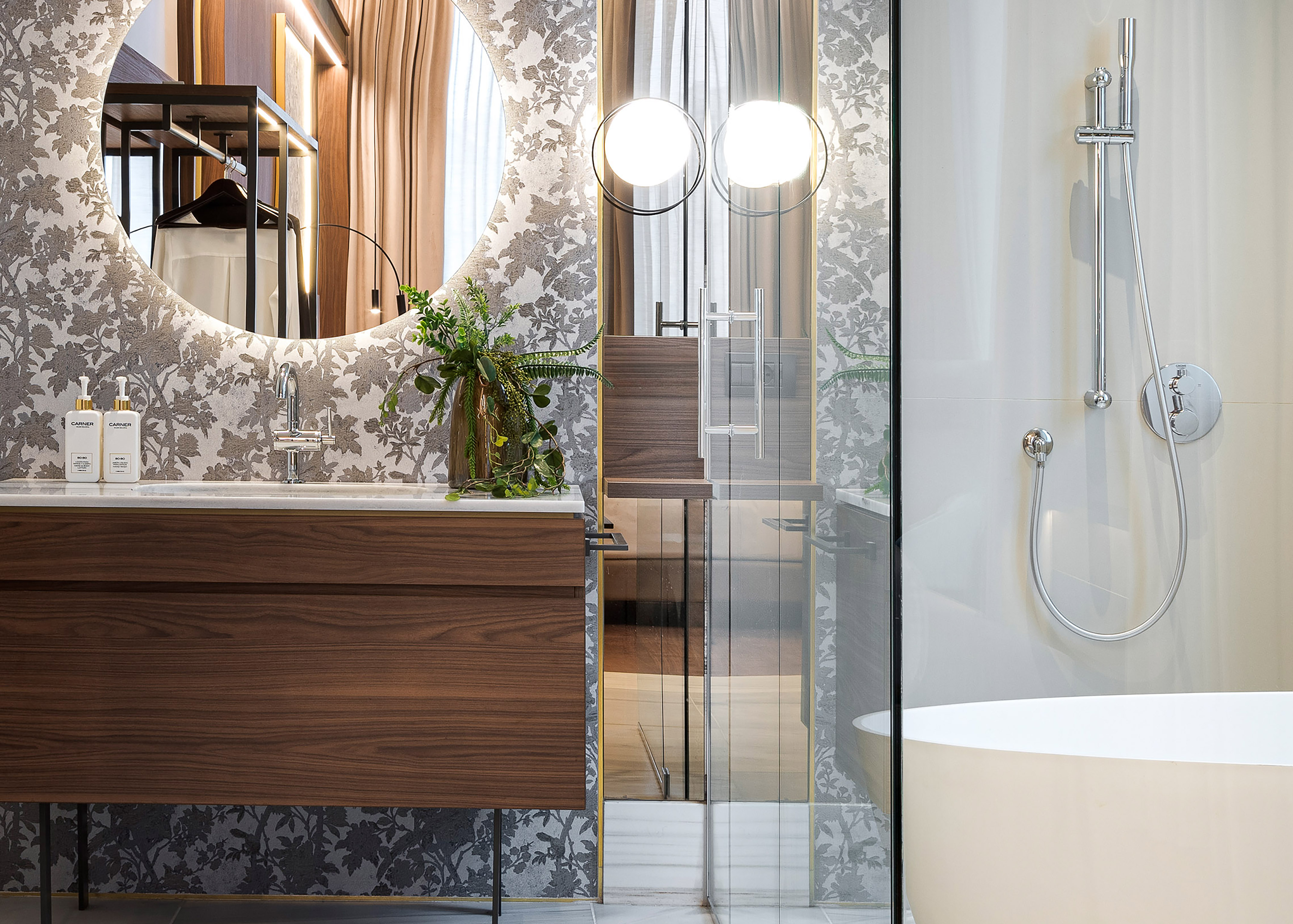 a bathroom with a sink and a round mirror
