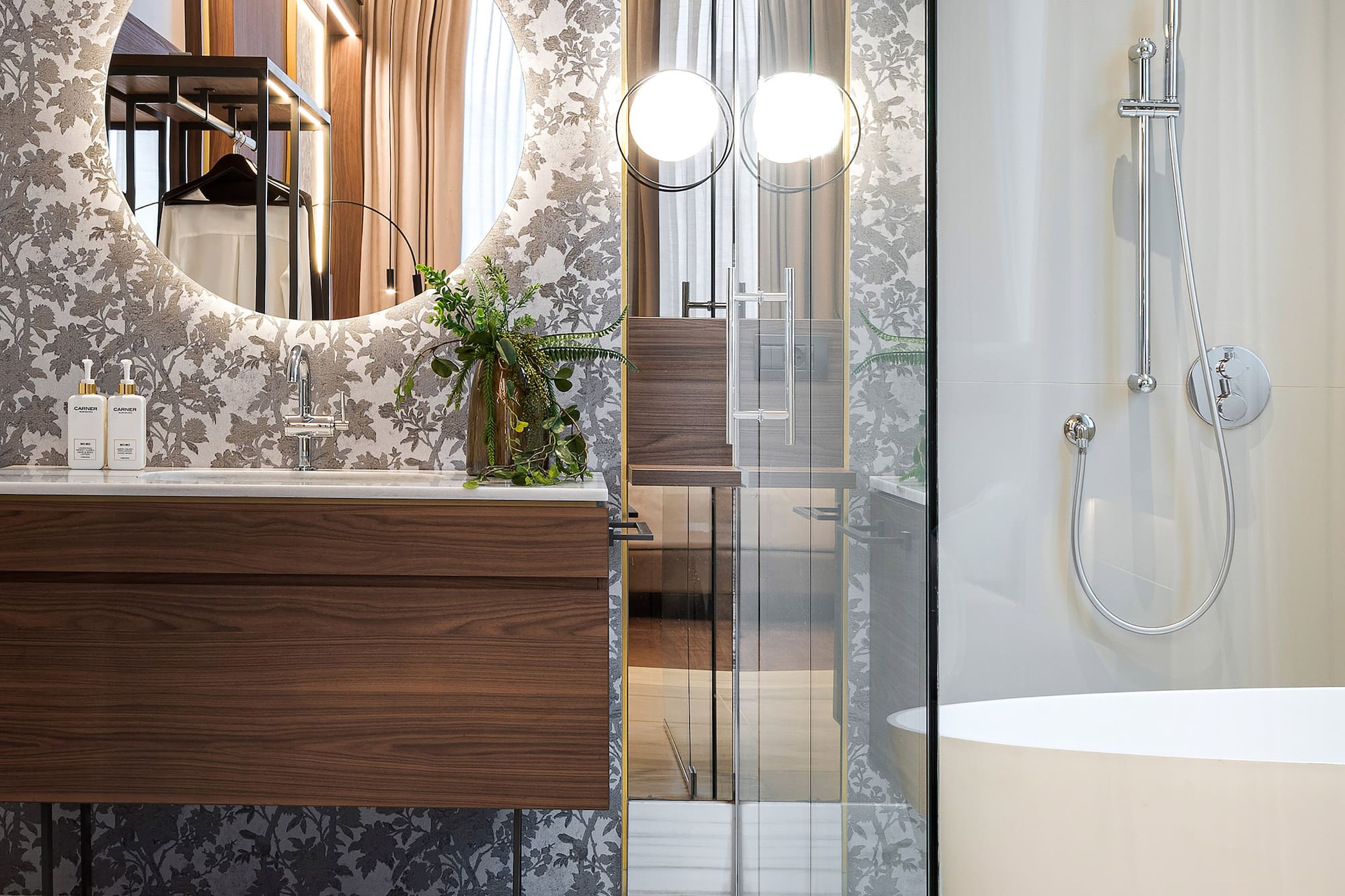 a bathroom with a sink and a round mirror