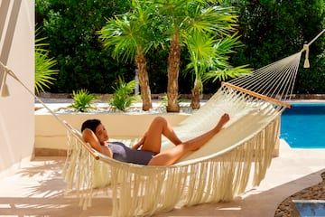 a woman lying in a hammock