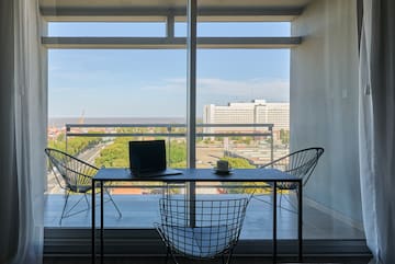 a table and chairs in a room with a view of a city