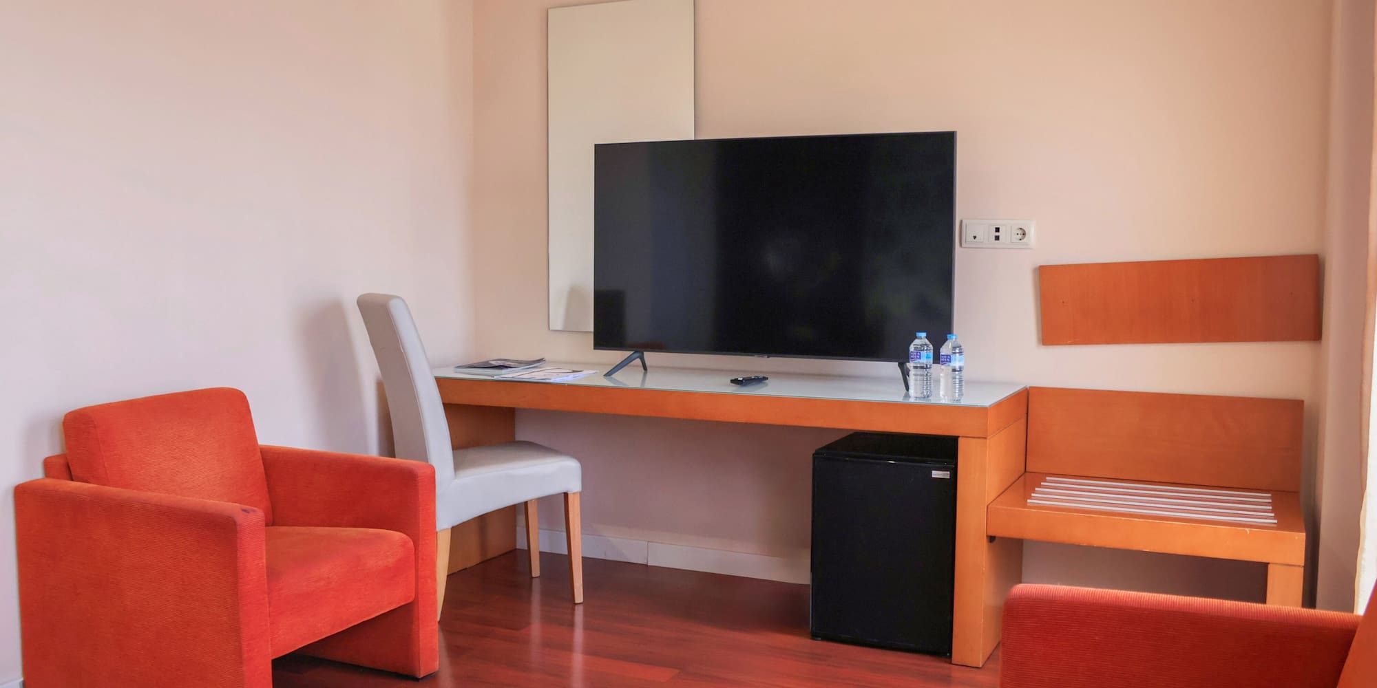 a room with a television and chairs