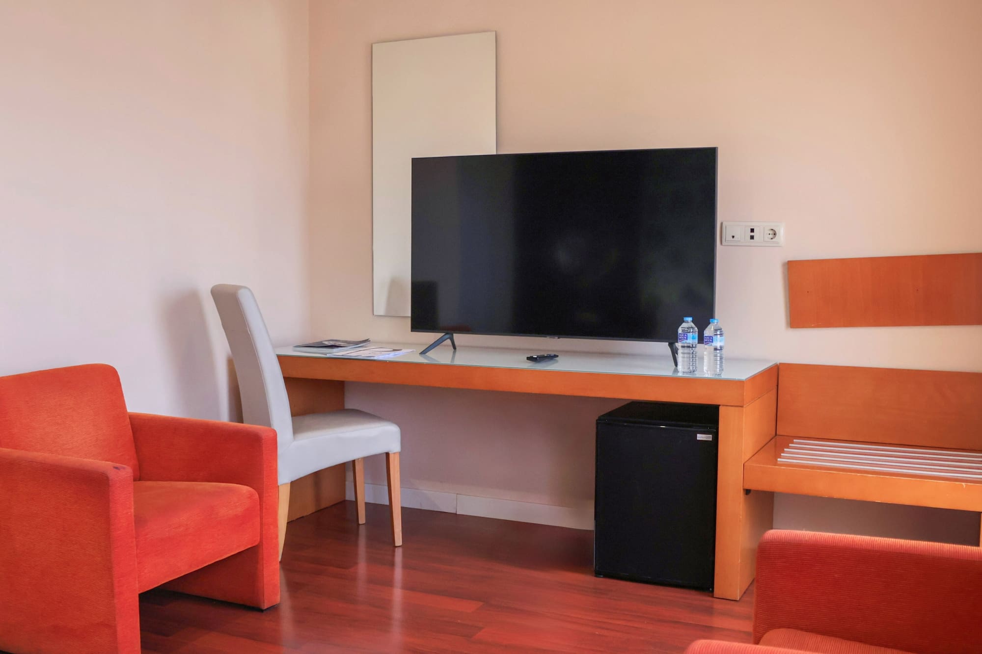 a room with a television and chairs