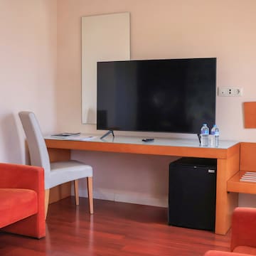 a room with a television and chairs