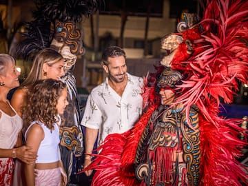 a group of people standing around a garmentd person