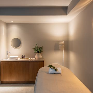 a massage room with a sink and a mirror