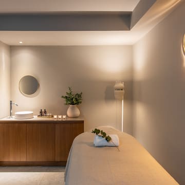 a massage room with a sink and a mirror