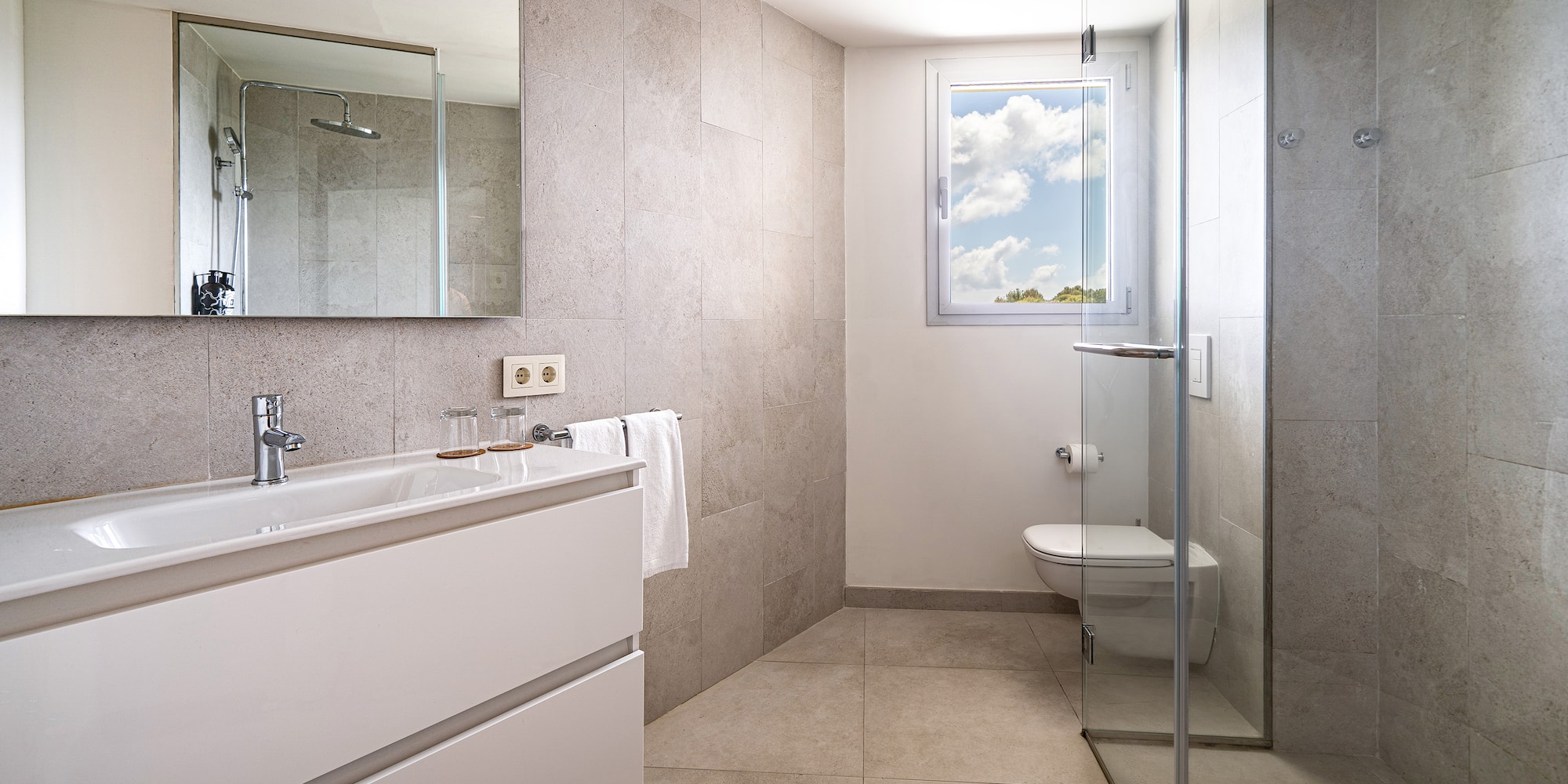 a bathroom with a glass shower door and sink