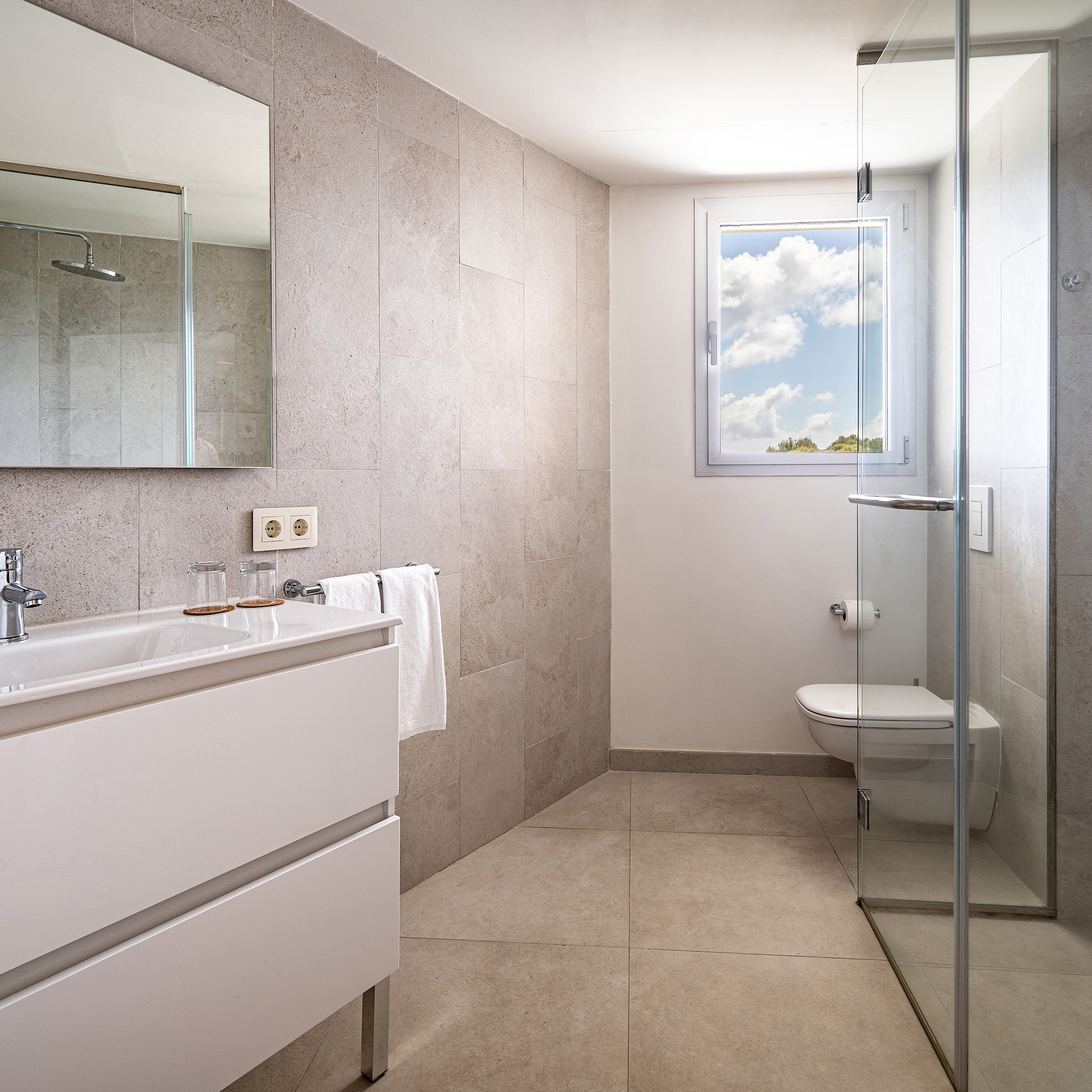 a bathroom with a glass shower door and sink