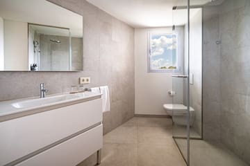 a bathroom with a glass shower door and sink