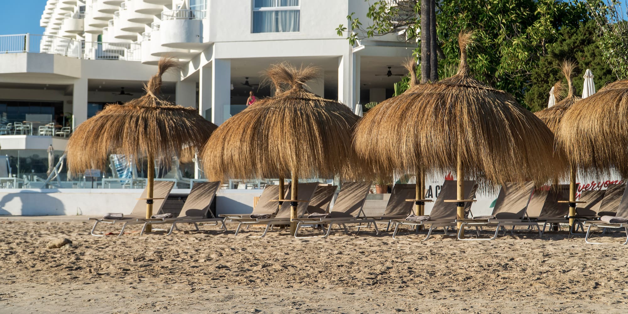 a group of chairs and umbrellas on a beach
