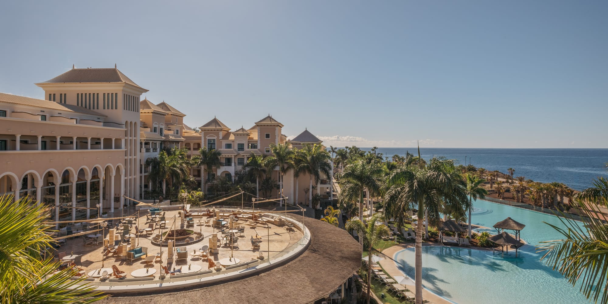 a pool and buildings with a large body of water