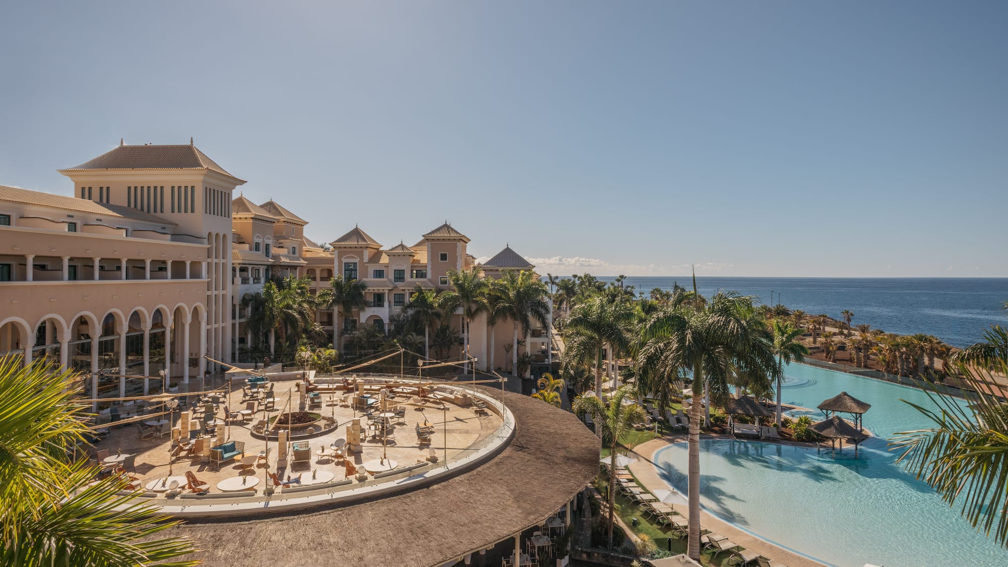 a pool and buildings with a large body of water