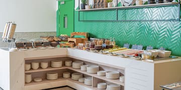 a buffet with plates and food on shelves