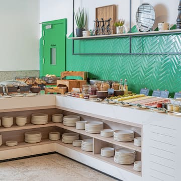 a buffet with plates and food on shelves