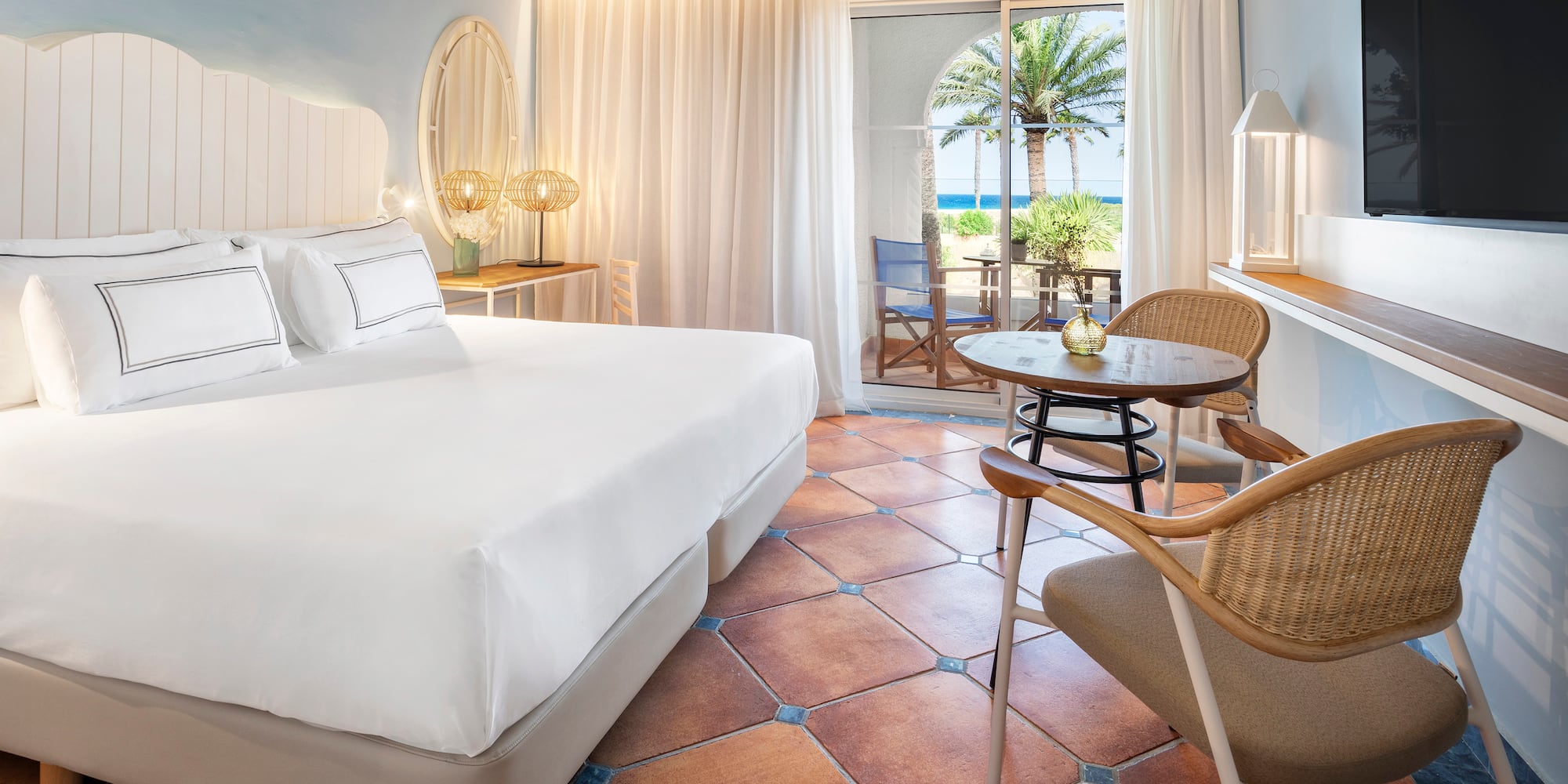 a room with a bed and chairs and a table