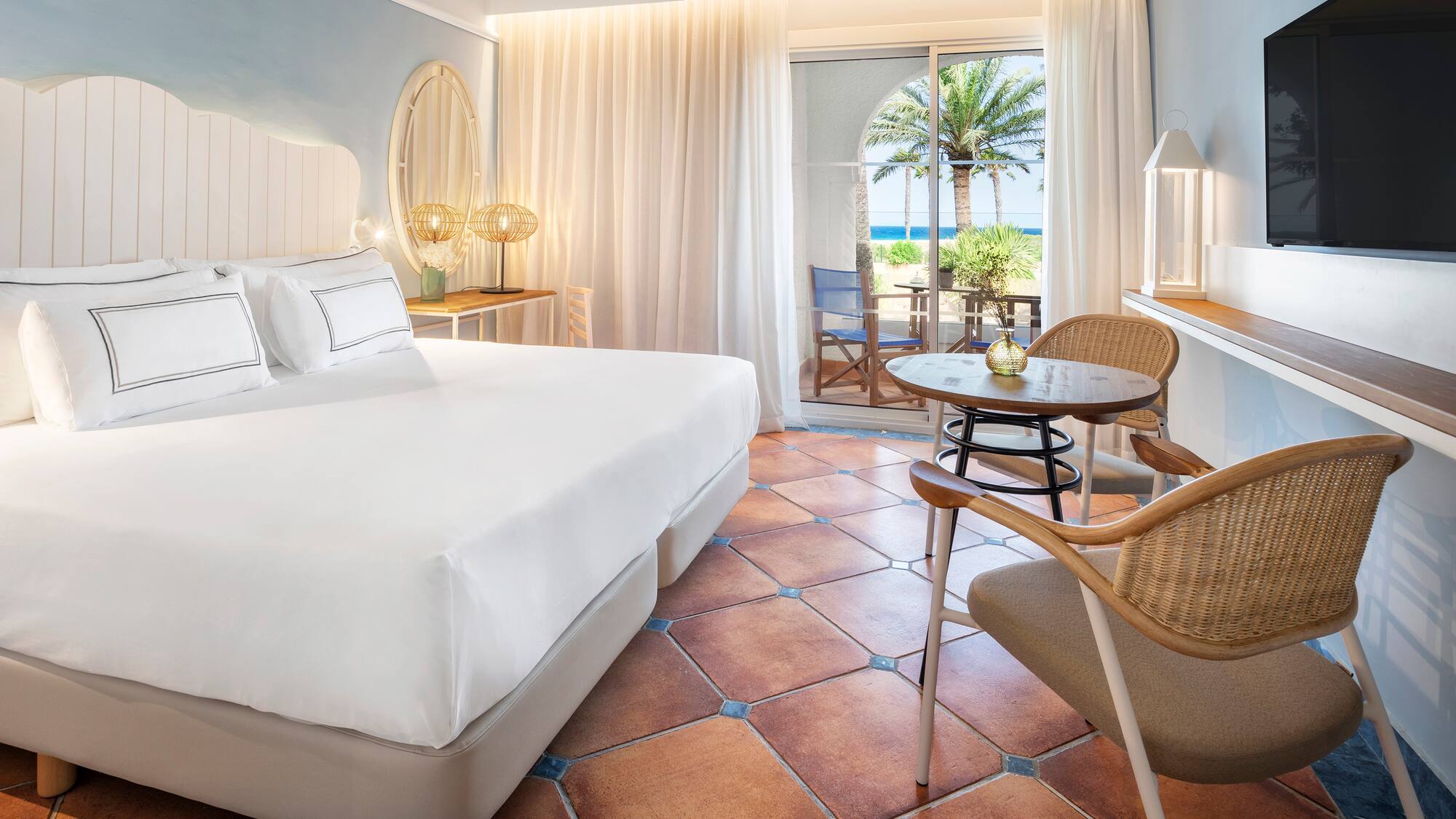 a room with a bed and chairs and a table