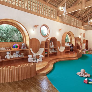 a room with a large playroom with a blue carpet and toys