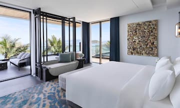 a bedroom with a bed and a couch
