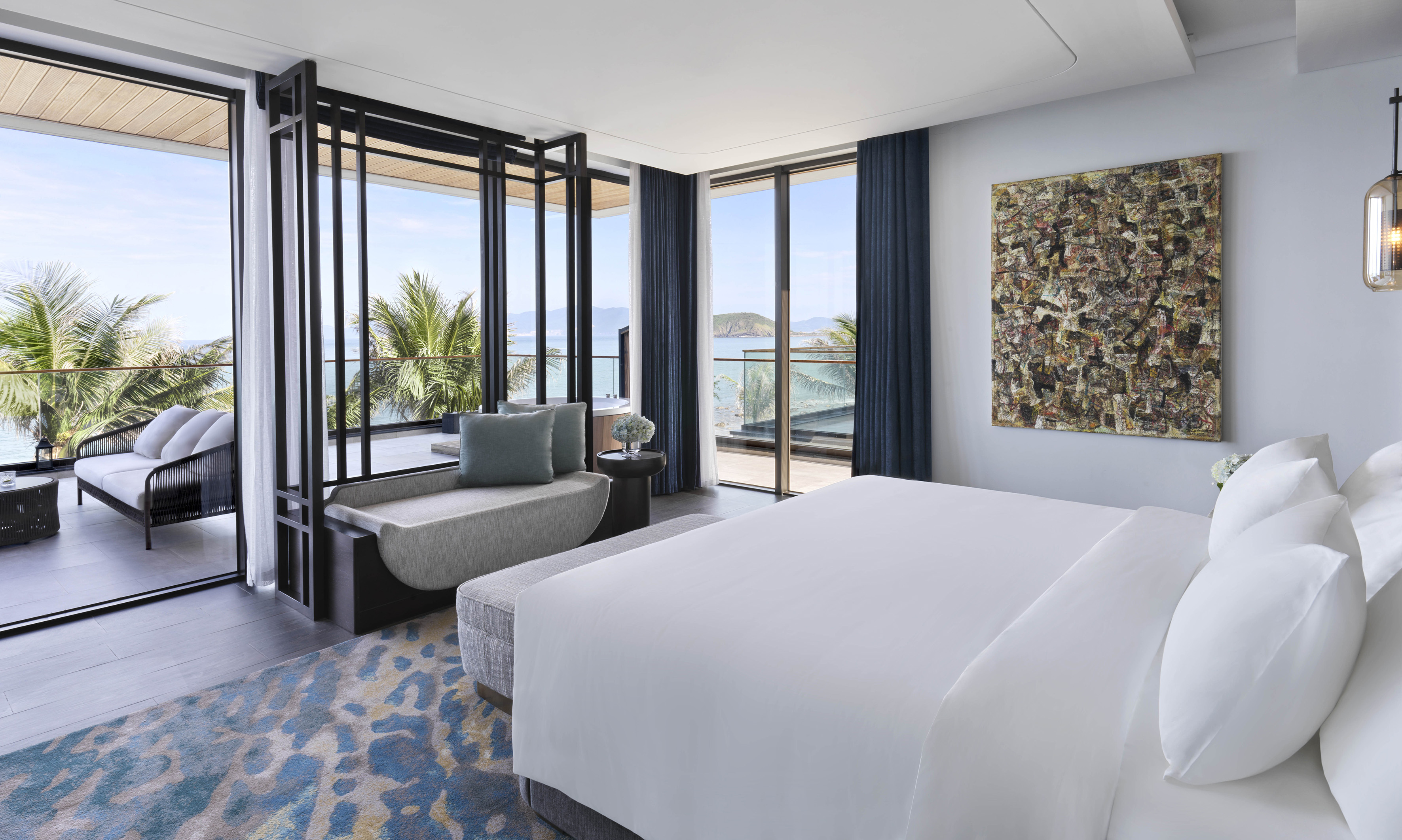 Luxury ocean view bedroom with balcony, tropical palm trees, and modern design.