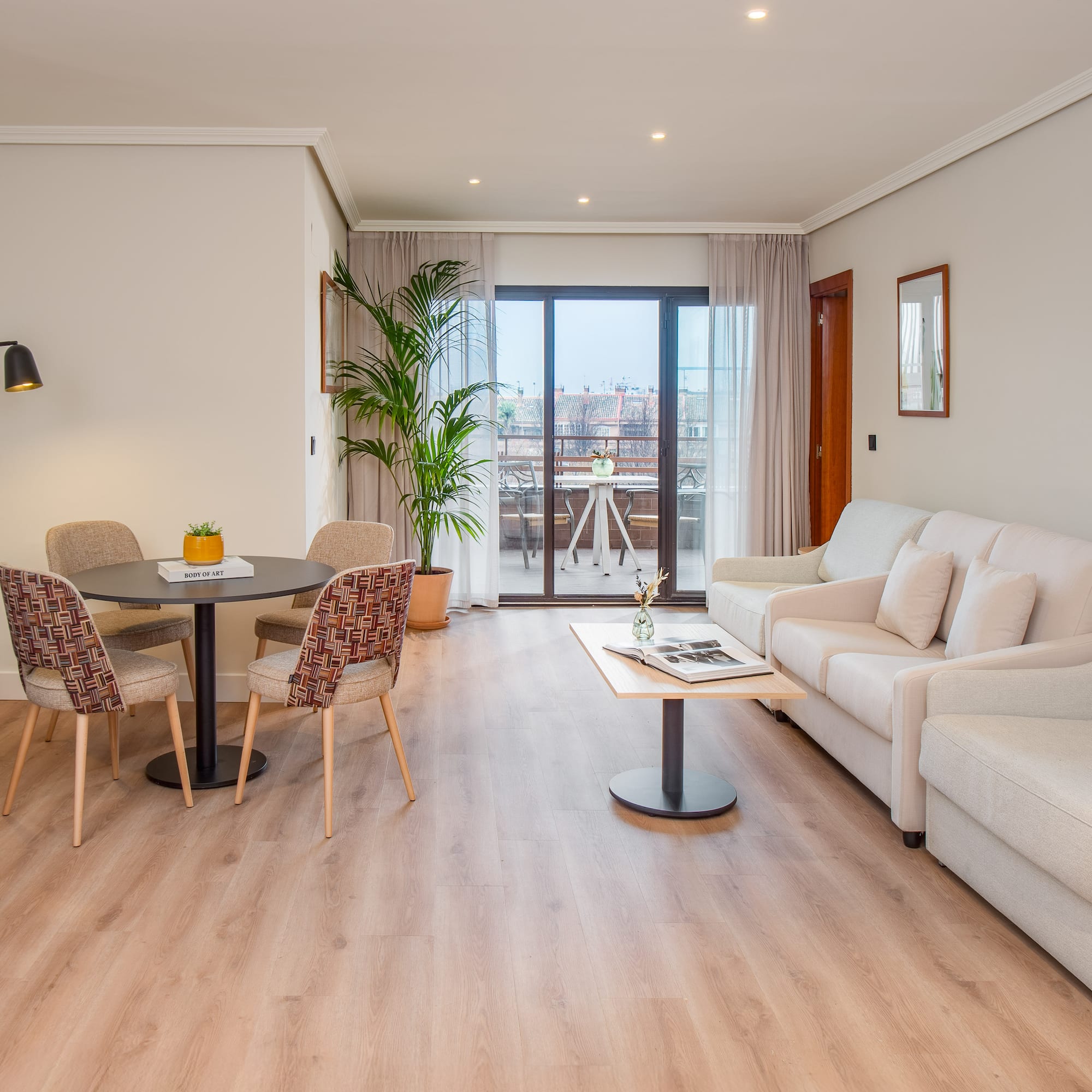 a living room with a table and chairs