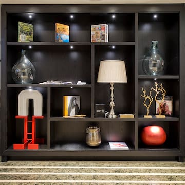 a black bookcase with various objects on it