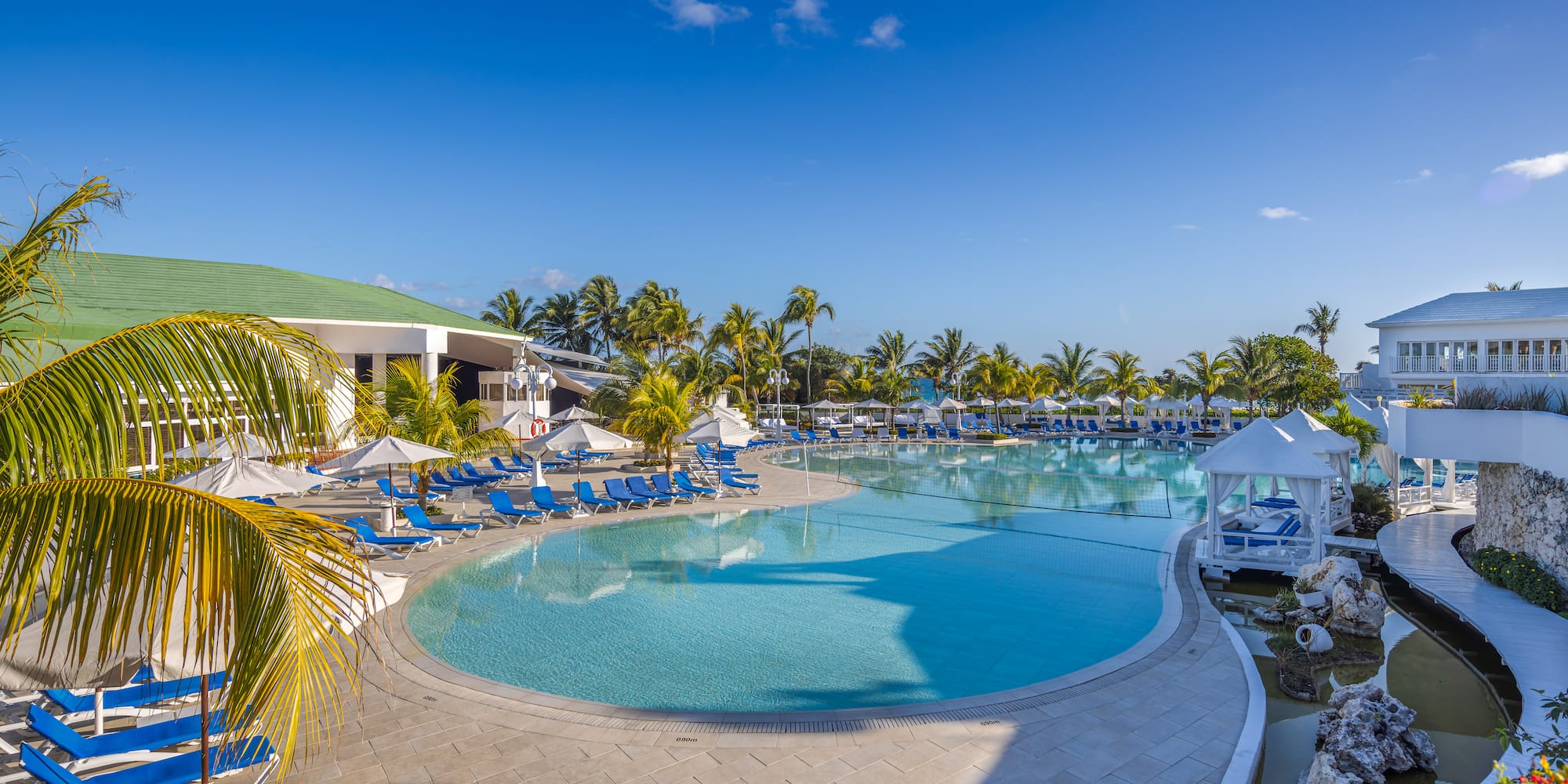 a pool with lounge chairs and umbrellas