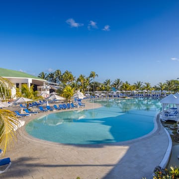 a pool with lounge chairs and umbrellas