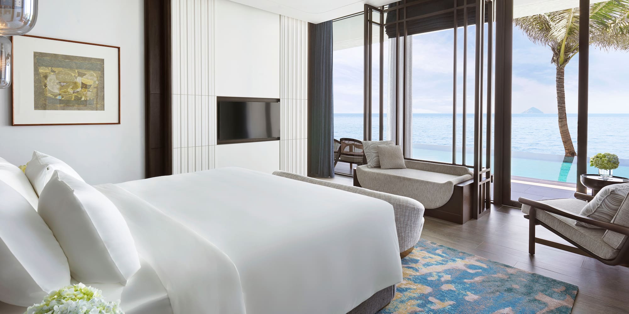 a room with a bed and a couch and a window