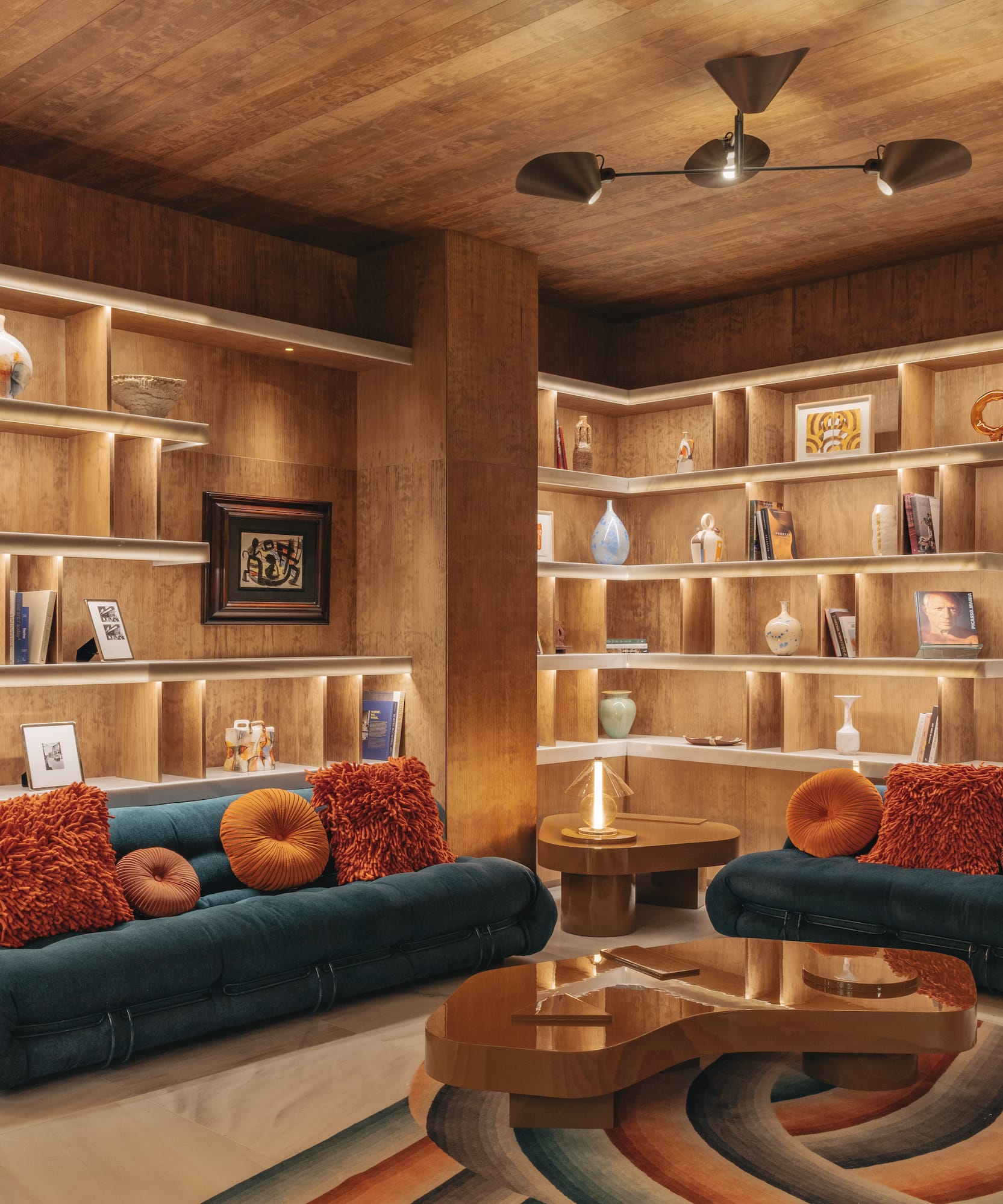 a room with shelves and couches