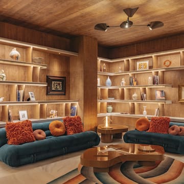 a room with shelves and couches