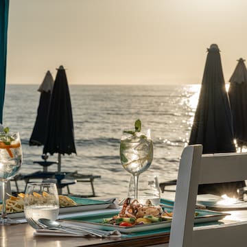 a table with food on it and a beach in the background