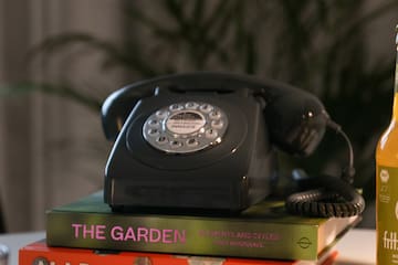 a telephone on top of books