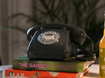 a telephone on top of books