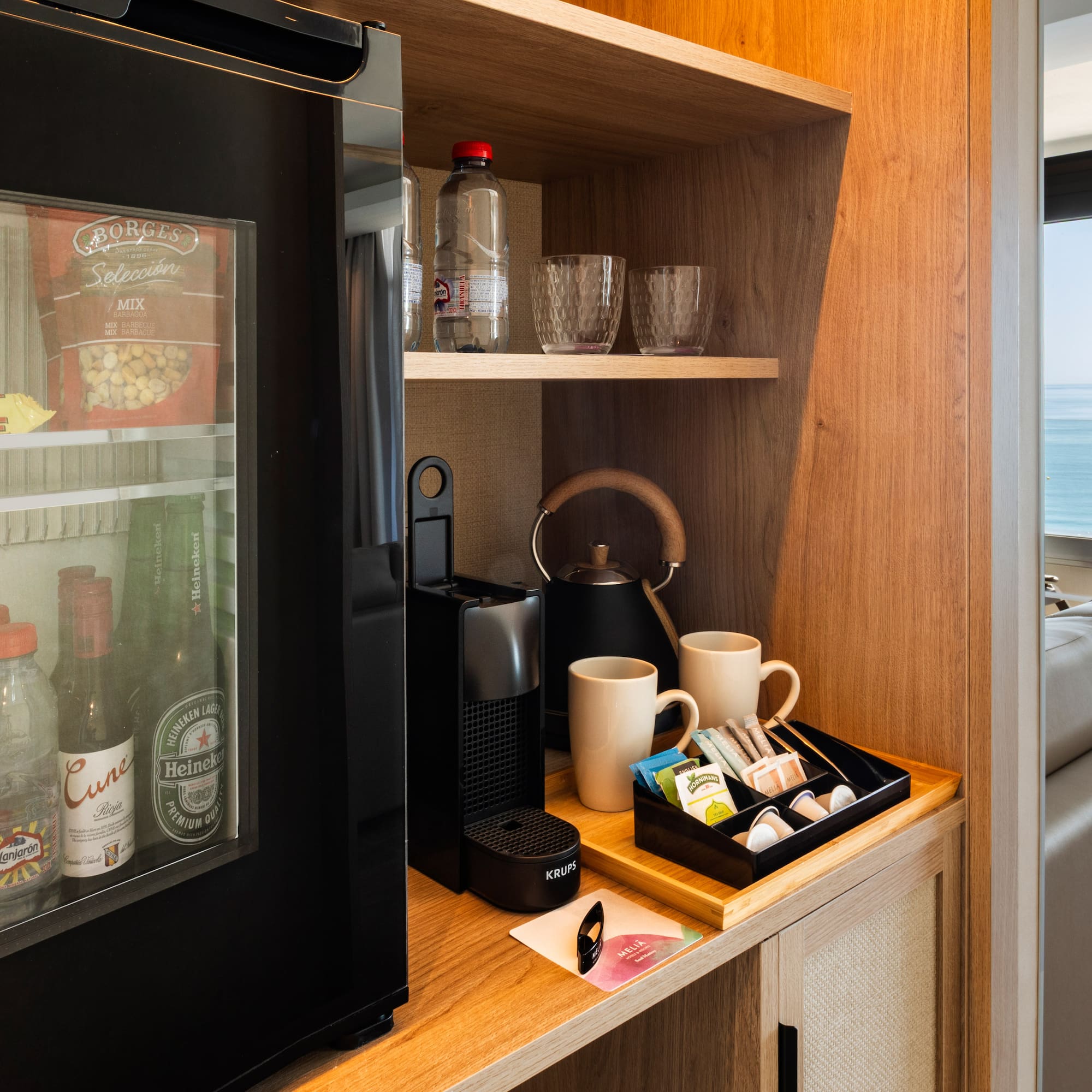 a coffee machine and coffee cups on a shelf
