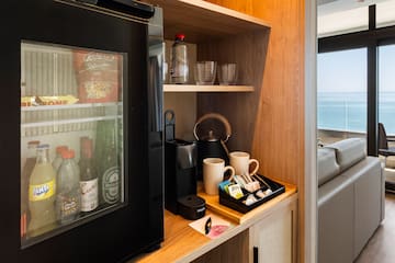 a coffee machine and coffee cups on a shelf