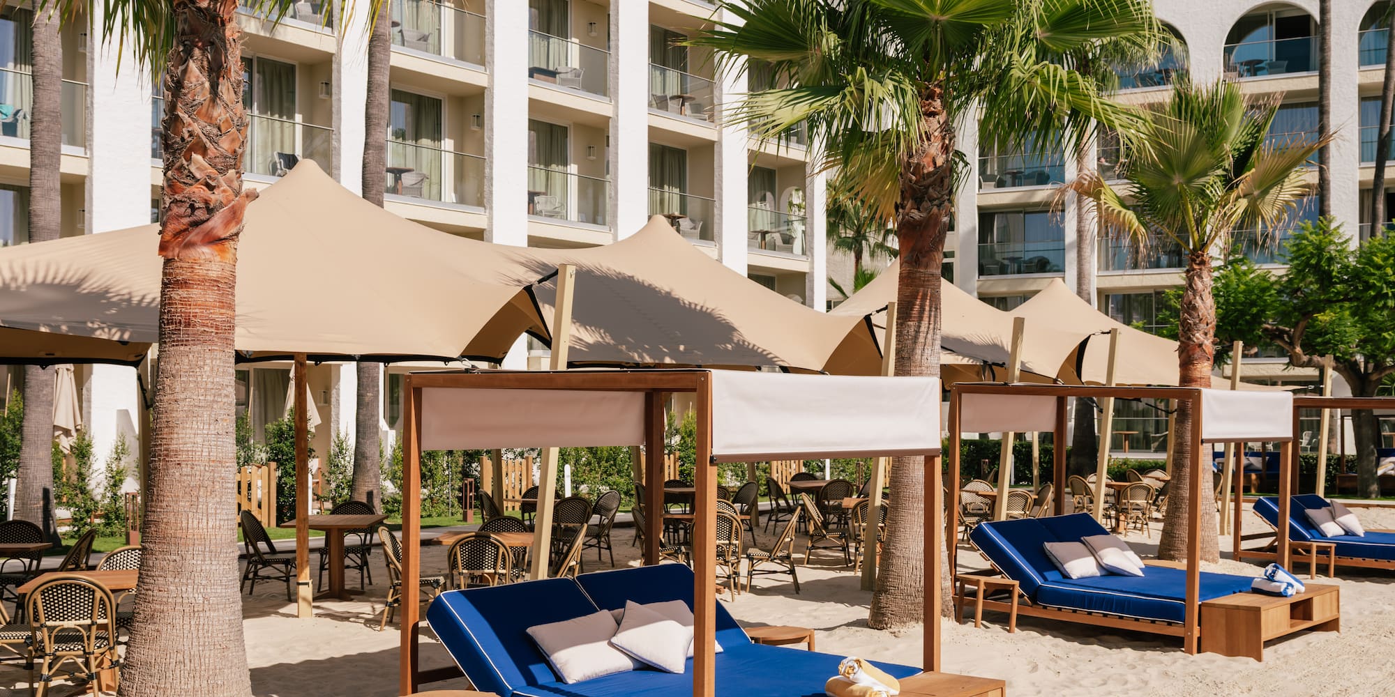 a beach chairs and umbrellas in a resort