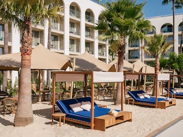 a beach chairs and umbrellas in a resort