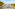 Beachfront hotel resort with swimming pools, sunbeds, palm trees, and ocean.