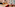 a room with a red couch and a table and chairs