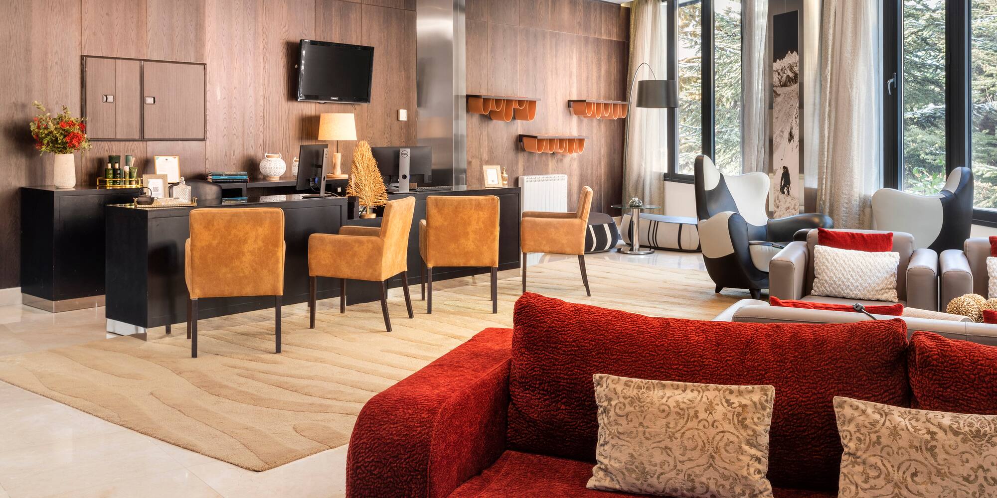 a room with a red couch and a table and chairs