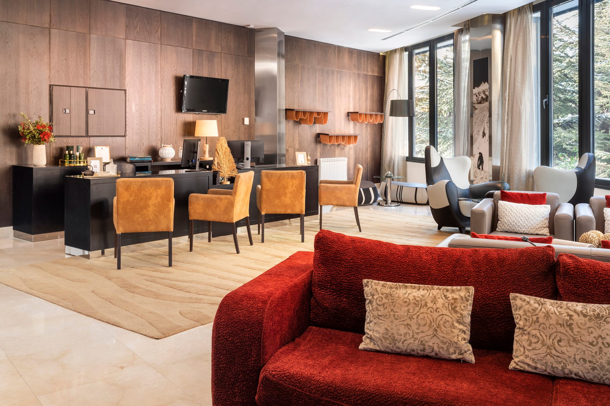 a room with a red couch and a table and chairs