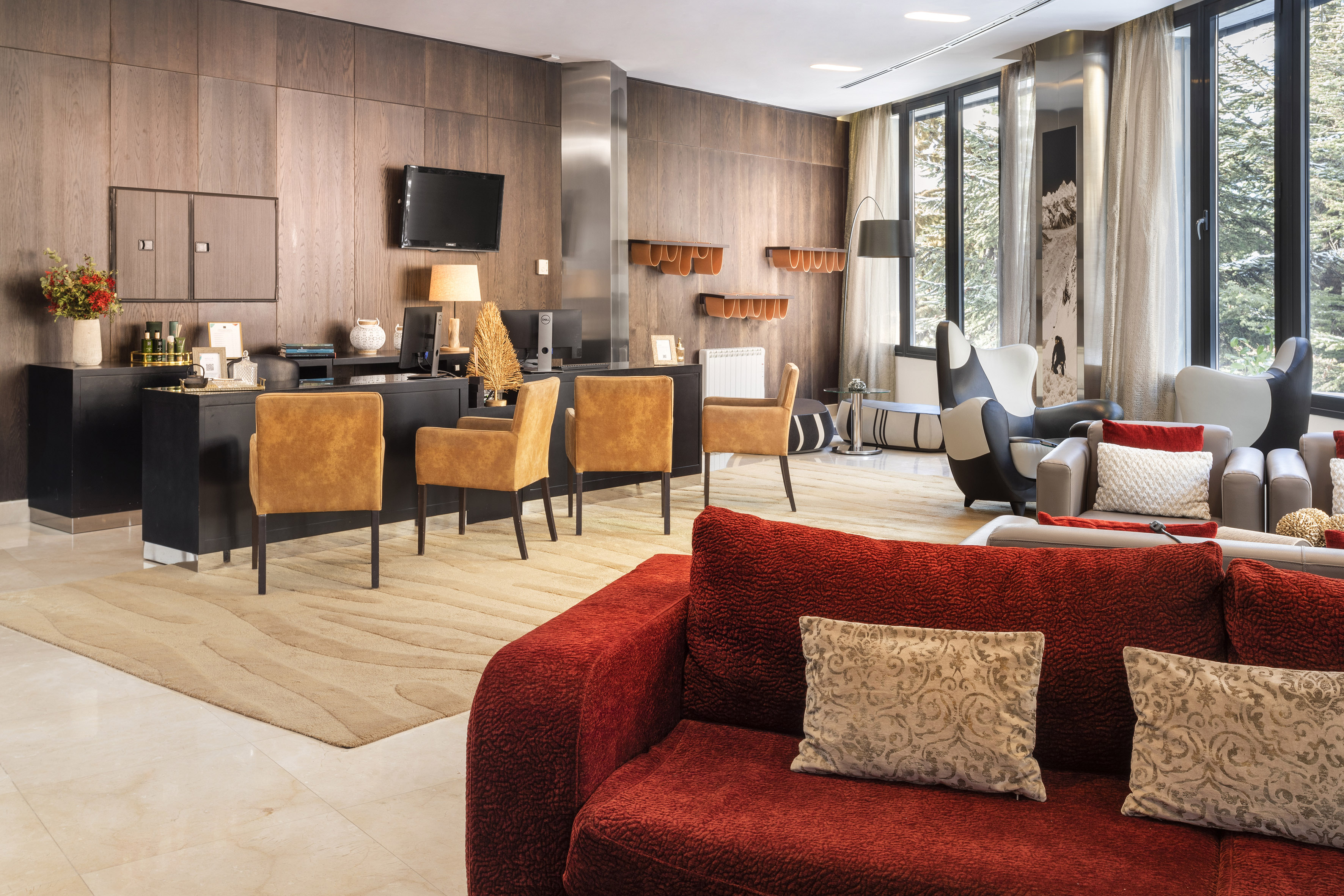 a room with a red couch and a table and chairs