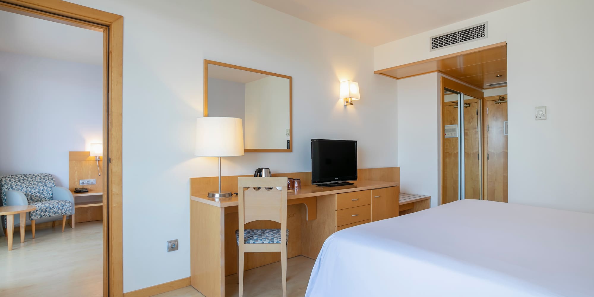 a room with a bed and a desk