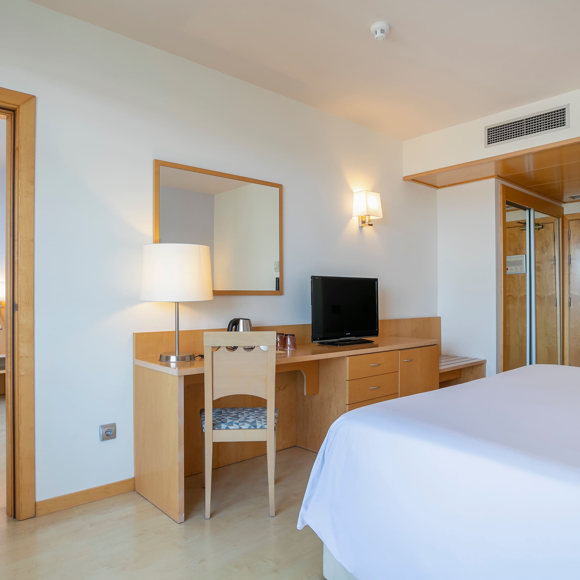 a room with a bed and a desk