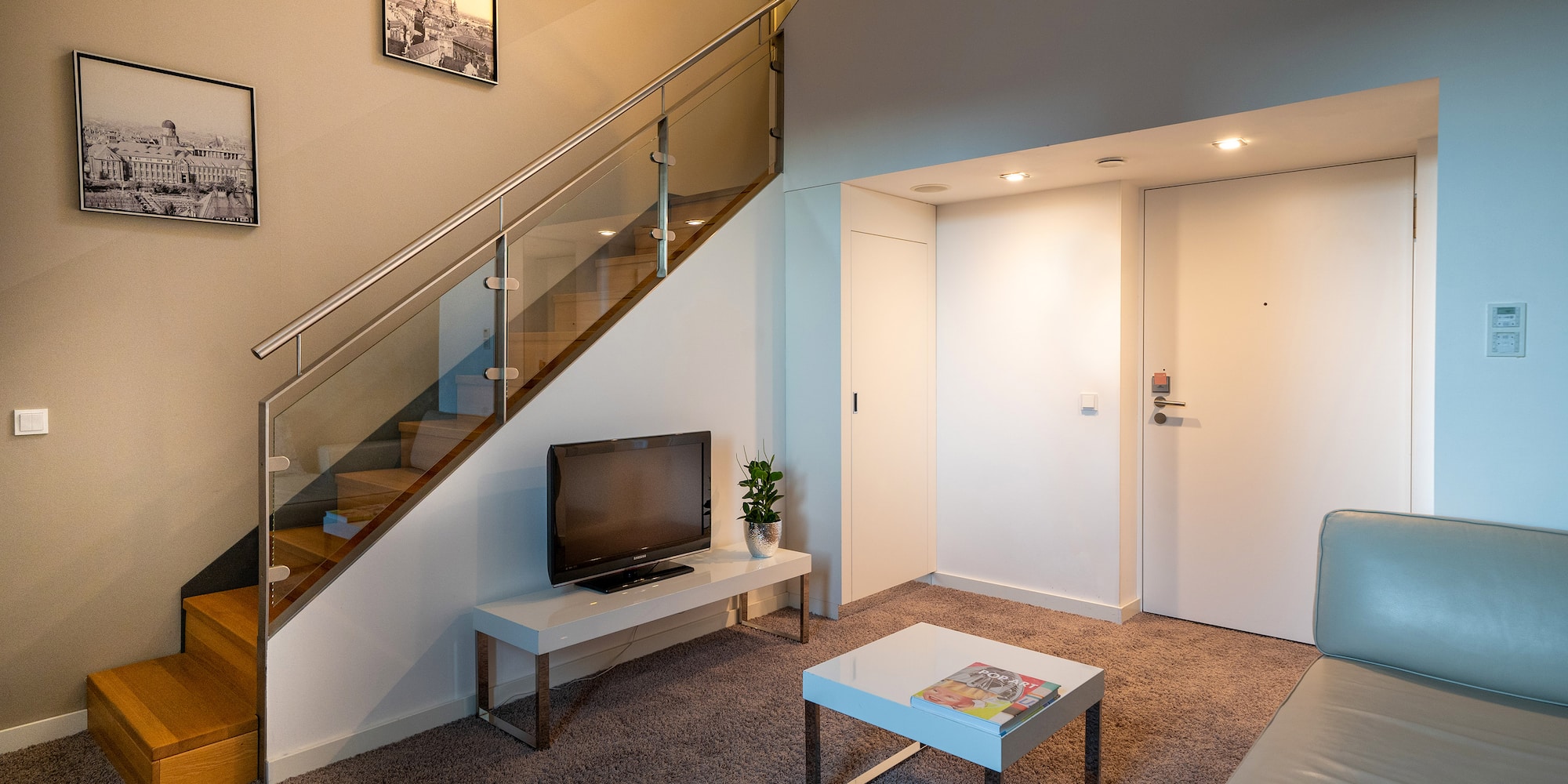 a living room with a staircase and a tv