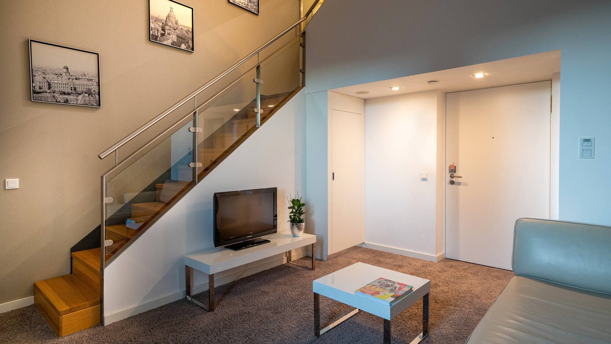 a living room with a staircase and a tv