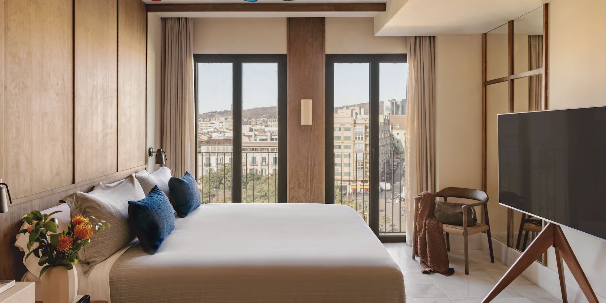 a bedroom with a large bed and a television