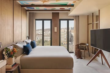 a bedroom with a large bed and a television