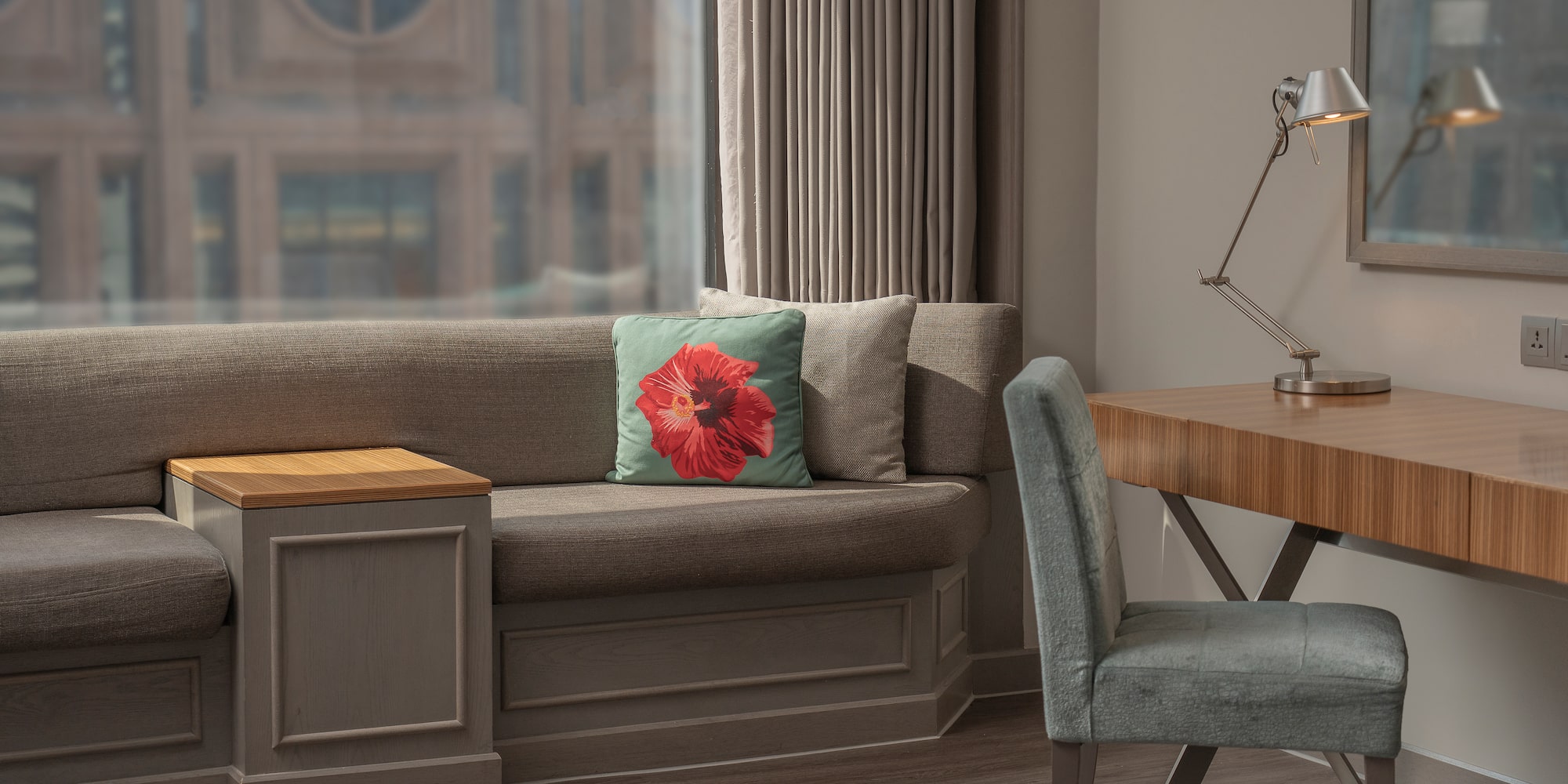 a couch with a pillow and a chair in a room