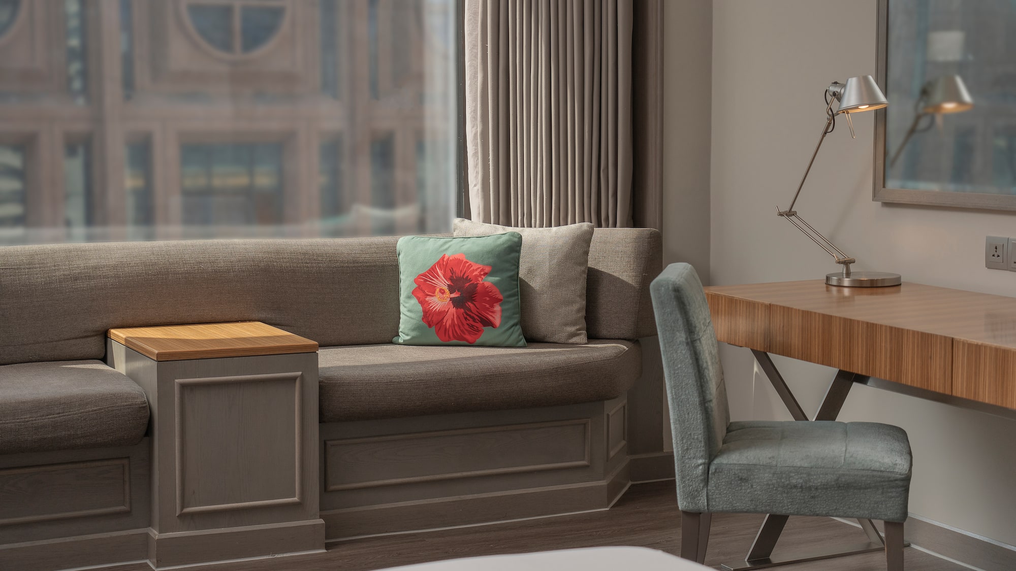 a couch with a pillow and a chair in a room